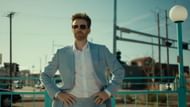 Reverend Drew Devlin embodies corruption in Honey Don’t! (Image via YouTube/Focus Features)
